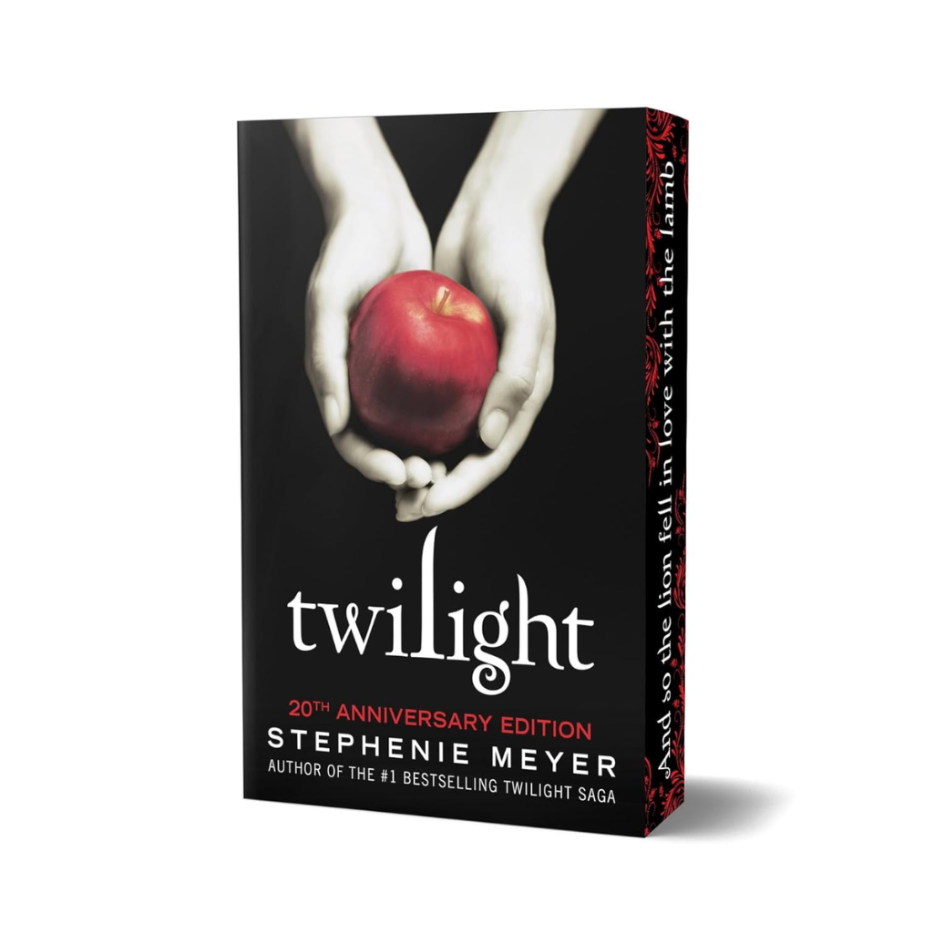 Book cover of 'Twilight' with hands holding a red apple on a black background