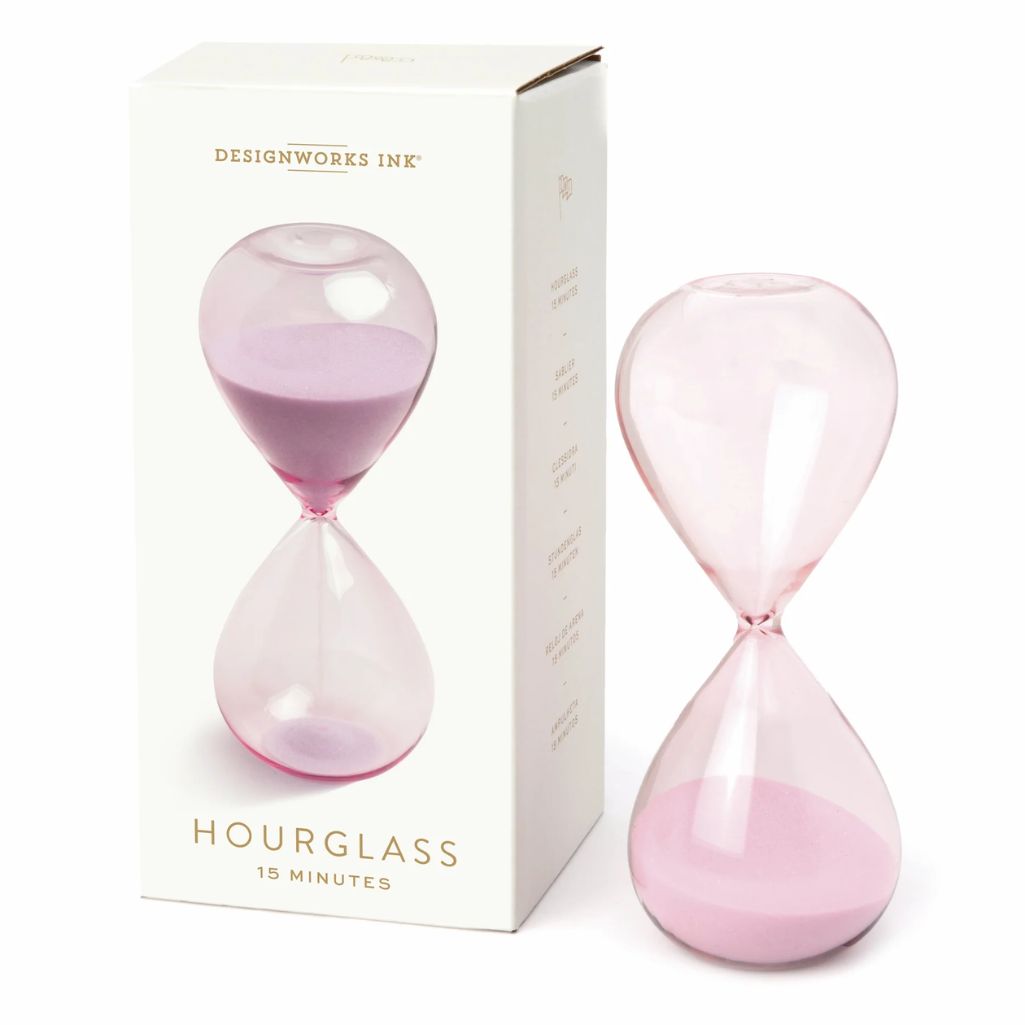 Lilac hourglass with sand and packaging on a white background