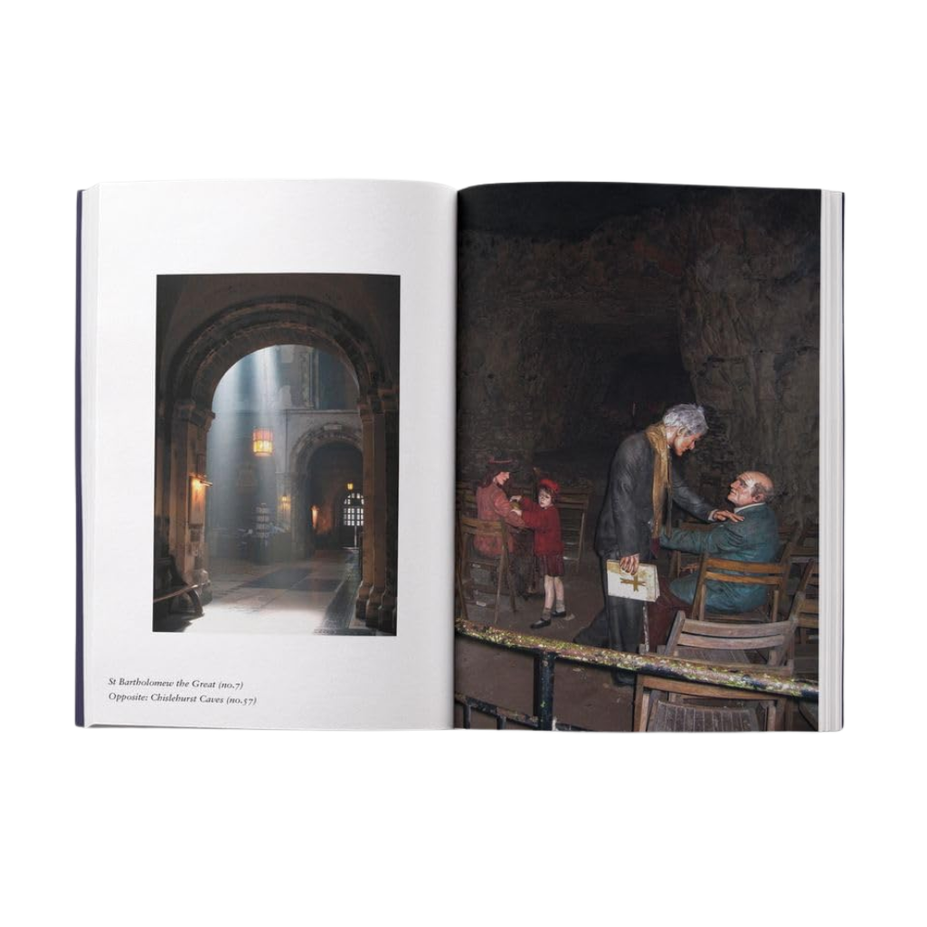 Open book showing a painting of two people in a dimly lit room.