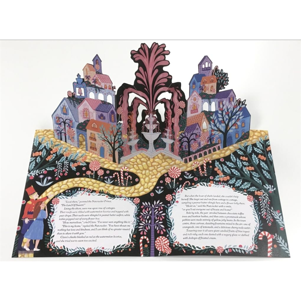 Decorative paper cutout with colorful houses and a fountain on a white background