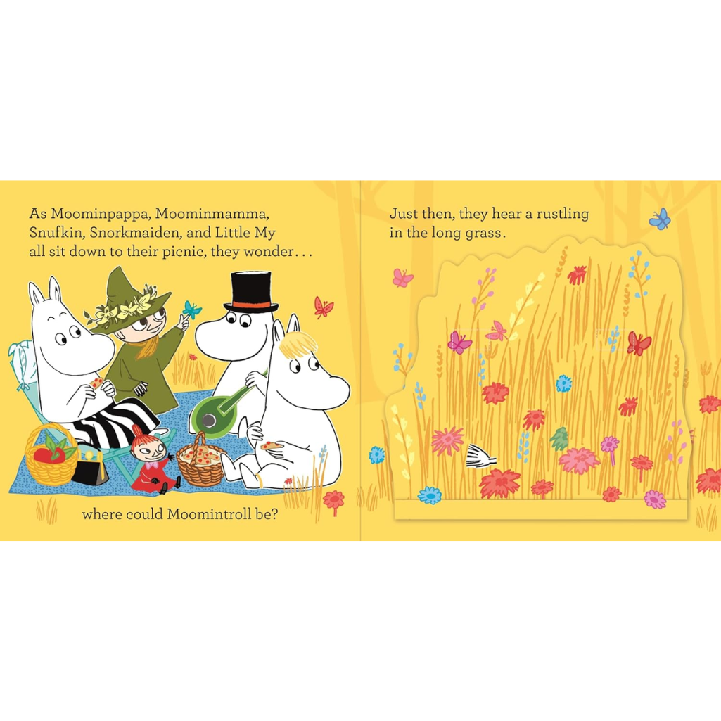 Illustrated book page with Moomin characters and a grassy scene.