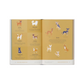 Open book with illustrations of dogs on a yellow background