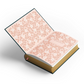 Open book with floral pattern on a white background