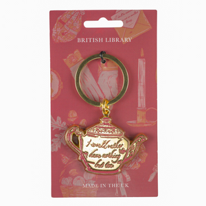 Teapot-shaped keychain with 'I would rather have nothing but tea' text on a pink British Library packaging.