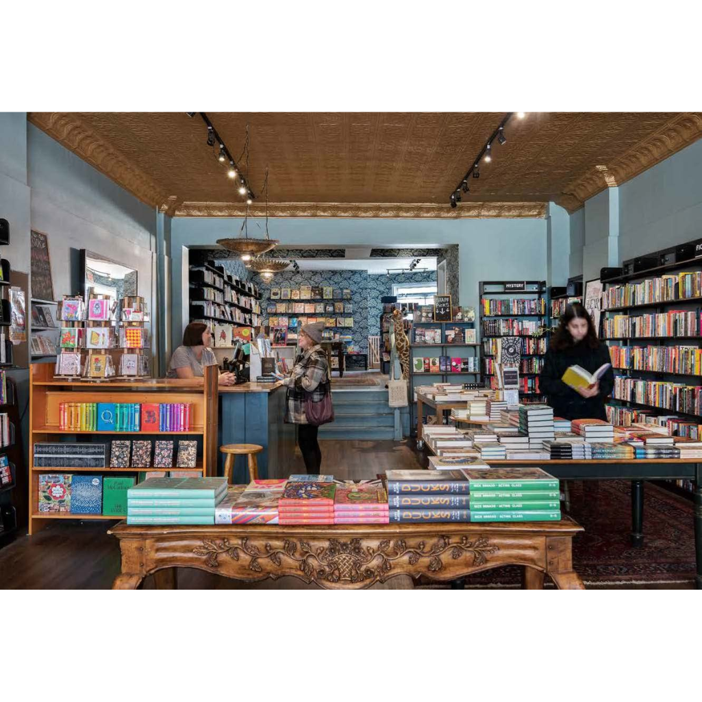 Interior of a bookstore with bookshelves and a counter.