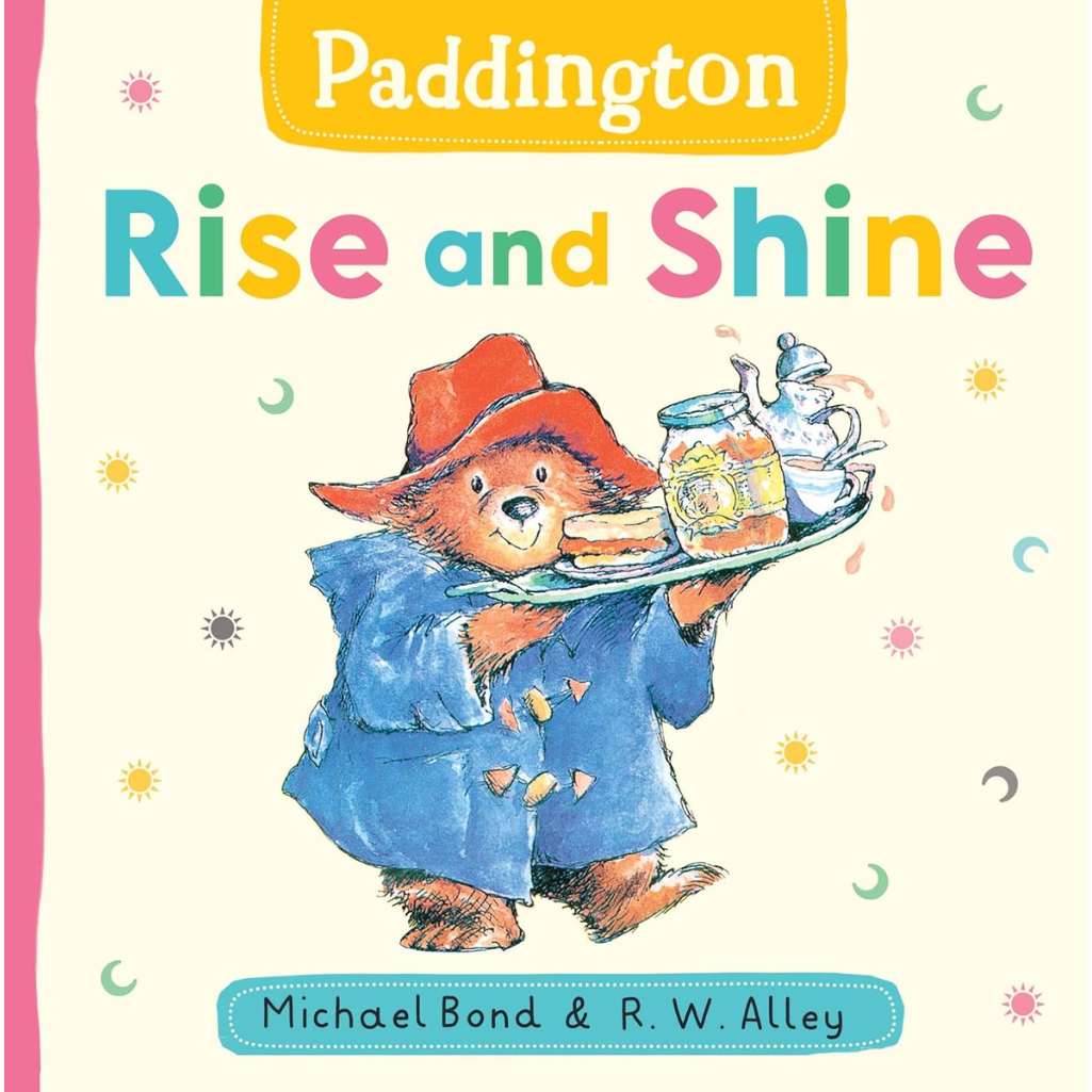 Book cover of 'Paddington Rise and Shine' with Paddington Bear holding a tray of food.