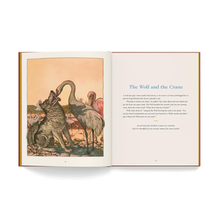 Open book showing illustration of 'The Wolf and the Crane' fable