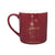 Burgundy mug with an illustration in gold of sugar cubes falling into a teacup