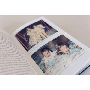 Open book with images of children and a dog on a light background
