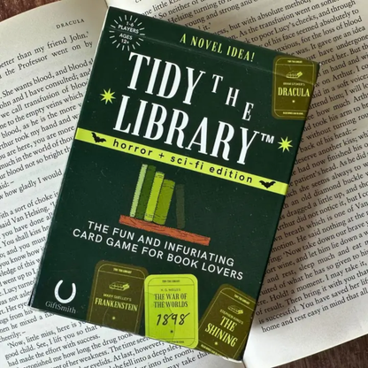 Card game packaging for 'Tidy the Library' on a book page