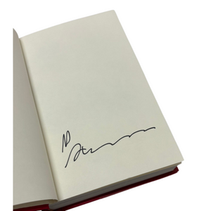 Open book with a signature on a white background