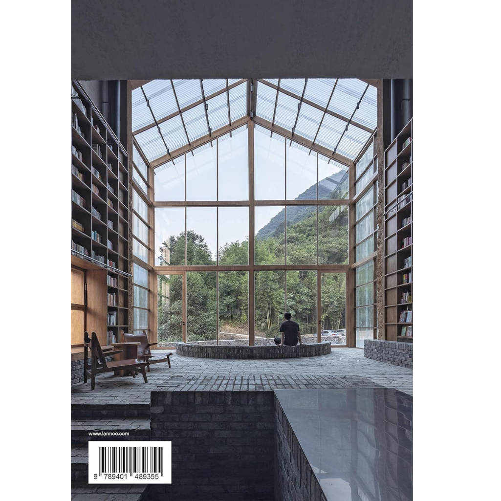 Modern architectural interior with large glass windows overlooking a mountainous landscape.