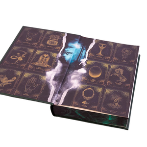 Decorative book with tarot card designs and a face on a white background