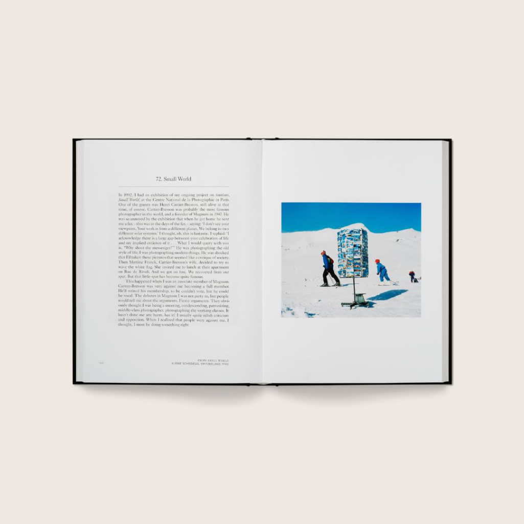 Open book with text and a photograph of people on a snowy landscape.