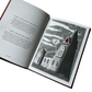 Open book with a black and white illustration of a church on a white background