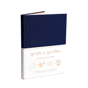 Blue notebook titled 'grids & guides' on a white background