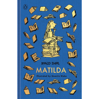 The front cover of the book 'Matilda' by Roald Dahl, illustrated by Quentin Blake, published by Penguin. The cover features a vibrant blue background with a central illustration of a girl sitting on a stack of books and surrounded by flying books, all in a yellow ink style.