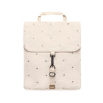 An off-white backpack with a top handle, featuring a flap closure decorated with with Ecru Dots, a central black metal clip, and a small tan brand tag at the bottom.