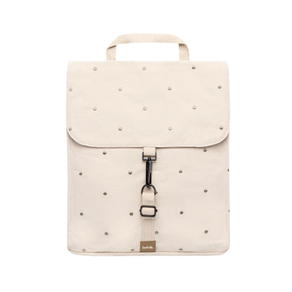 An off-white backpack with a top handle, featuring a flap closure decorated with with Ecru Dots, a central black metal clip, and a small tan brand tag at the bottom.