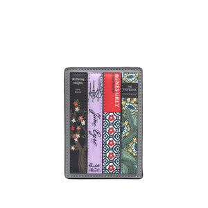 A slim leather card holder wallet featuring a vertical multicolor patterned design inspired by book spines, including black, lavender, red, green, and floral motifs, set against a light gray background.
