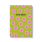 Notebook with pink flowers and smiley faces on a green background, labeled 'Cute Ideas'.