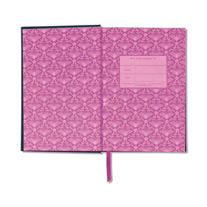 An open notebook or journal with a pink damask patterned cover and matching pink ribbon bookmark, shown on a plain white background.