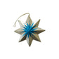 Decorative star ornament with blue center and gold edges on a white background