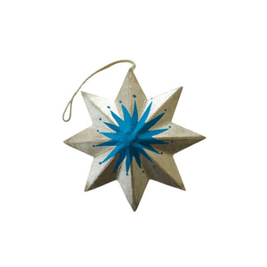 Decorative star ornament with blue center and gold edges on a white background