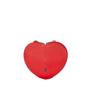 A bright red heart-shaped leather clutch bag with a small silver-toned logo plaque on the front, set against a light gray background.