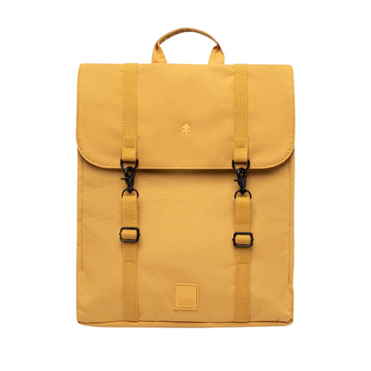 A mustard yellow backpack with a top handle, two front buckle straps, and a small square logo patch near the bottom, shown against a plain white background.