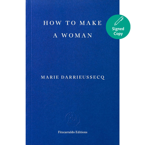 A hardcover book titled 'HOW TO MAKE A WOMAN' by Marie Darrieussecq, published by Fitzcarraldo Editions. The cover is a solid deep blue with white text.