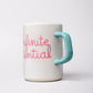 Mug with 'infinite potential' text and a turquoise handle on a light gray background
