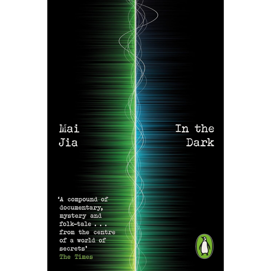 Book cover of 'In the Dark' by Mai Jia, featuring a black background with a vertical split of green and blue light streaks, white title and author text, a quote from The Times, and the Penguin logo.