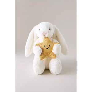 White plush bunny holding a gold star with a smiley face on a light gray background