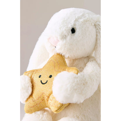 White plush bunny holding a yellow star-shaped toy with a smiley face on a light gray background