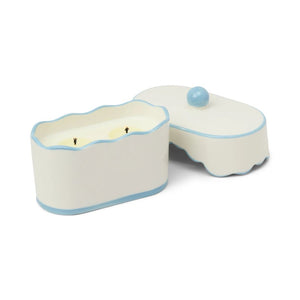 Ceramic candle holder with a candle inside on a white background