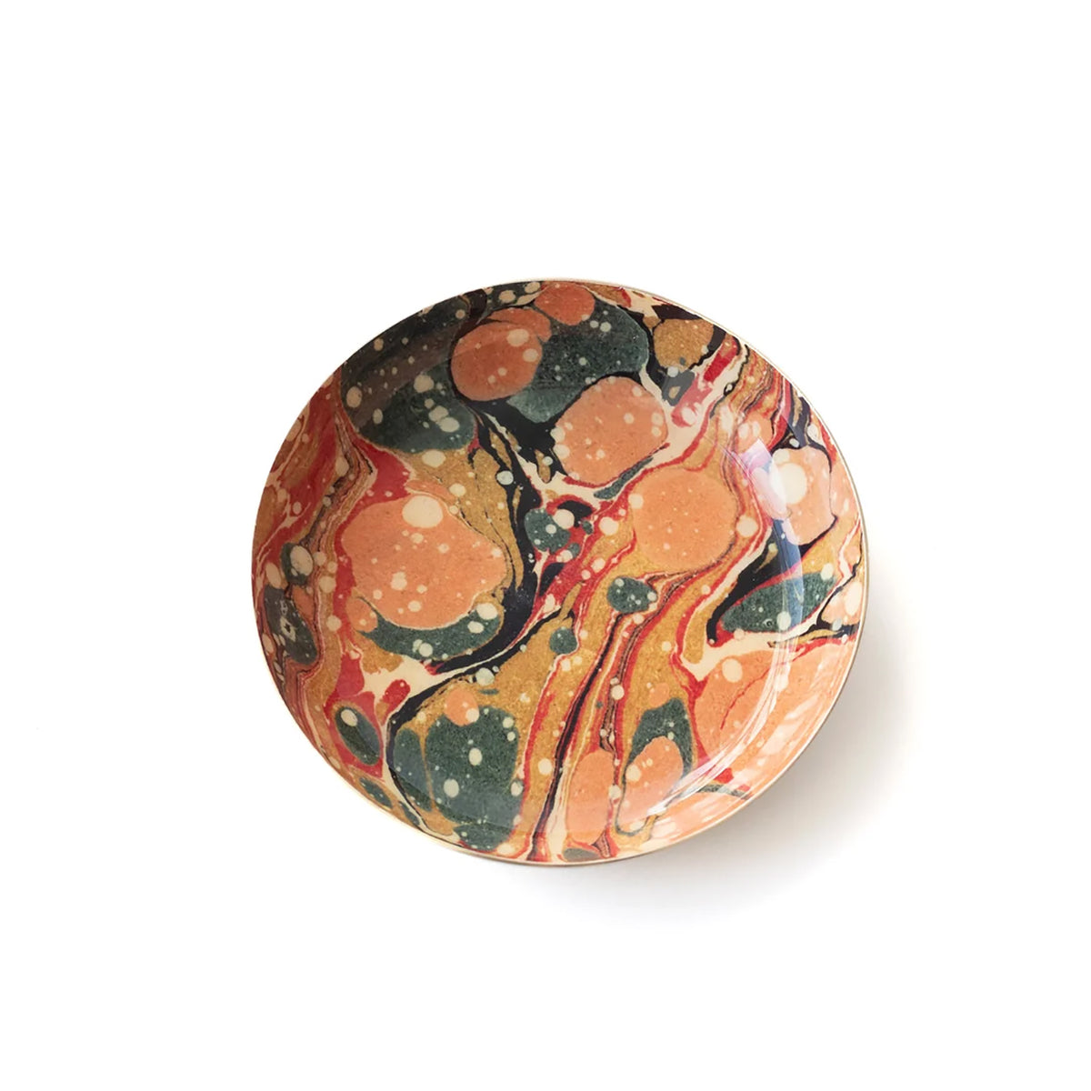 A round ceramic plate with a vibrant marbled paint pattern in orange, red, black, and cream, photographed from directly above on a white background.