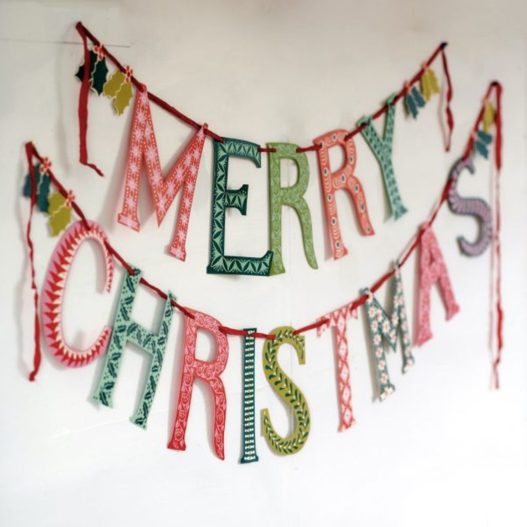 Decorative 'Merry Christmas' banner with colourful letters on a white background