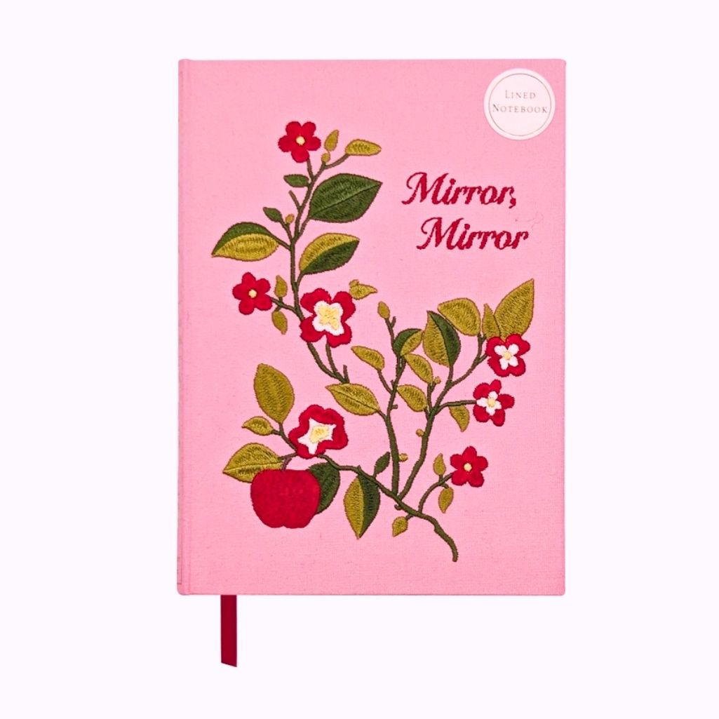 Pink notebook with floral design and 'Mirror, Mirror' text on a white background