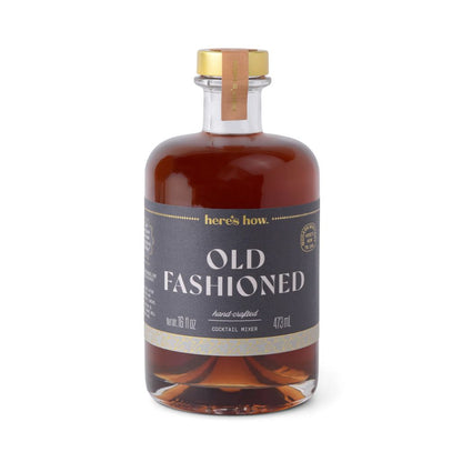 Bottle of 'Old Fashioned' cocktail mixer with a gold cap on a white background