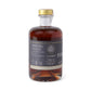 Bottle of old fashioned mixer with a gold cap on a white background
