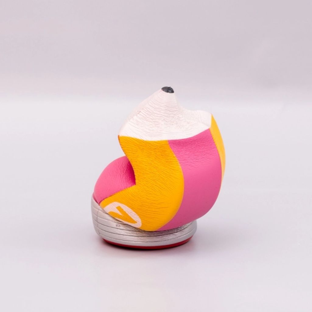 Squashed pencil shaped stress ball on a white background