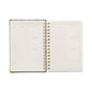 Open planner with weekly/monthly layout on a white background