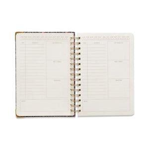 Open planner with weekly/monthly layout on a white background