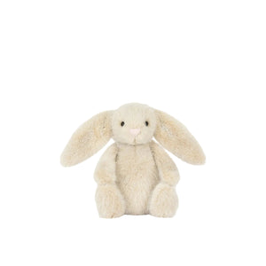 Cream-colored bunny plush toy on a white background