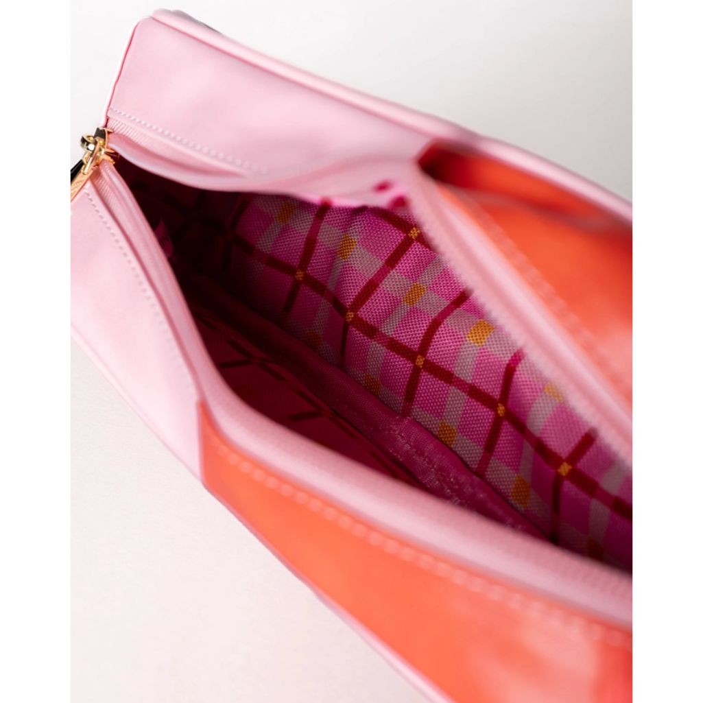Close-up of a pink and orange pouch with a grid pattern inside.