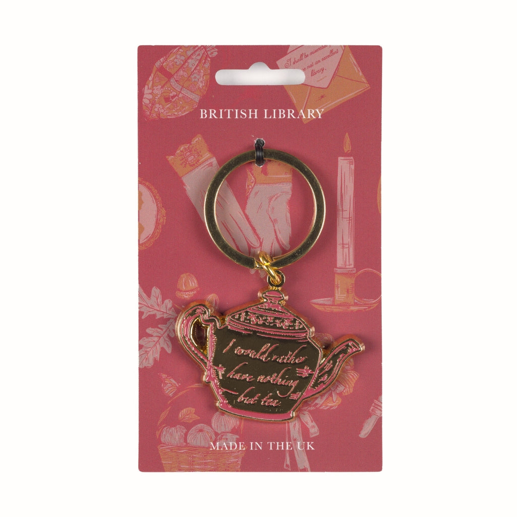 Teapot-shaped keychain with 'I would rather have nothing but tea' text on a pink British Library packaging.