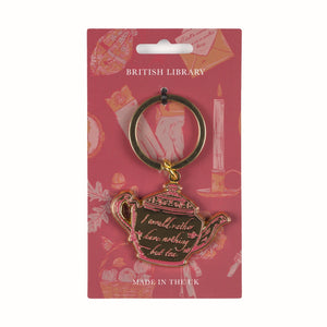 Teapot-shaped keychain with 'I would rather have nothing but tea' text on a pink British Library packaging.