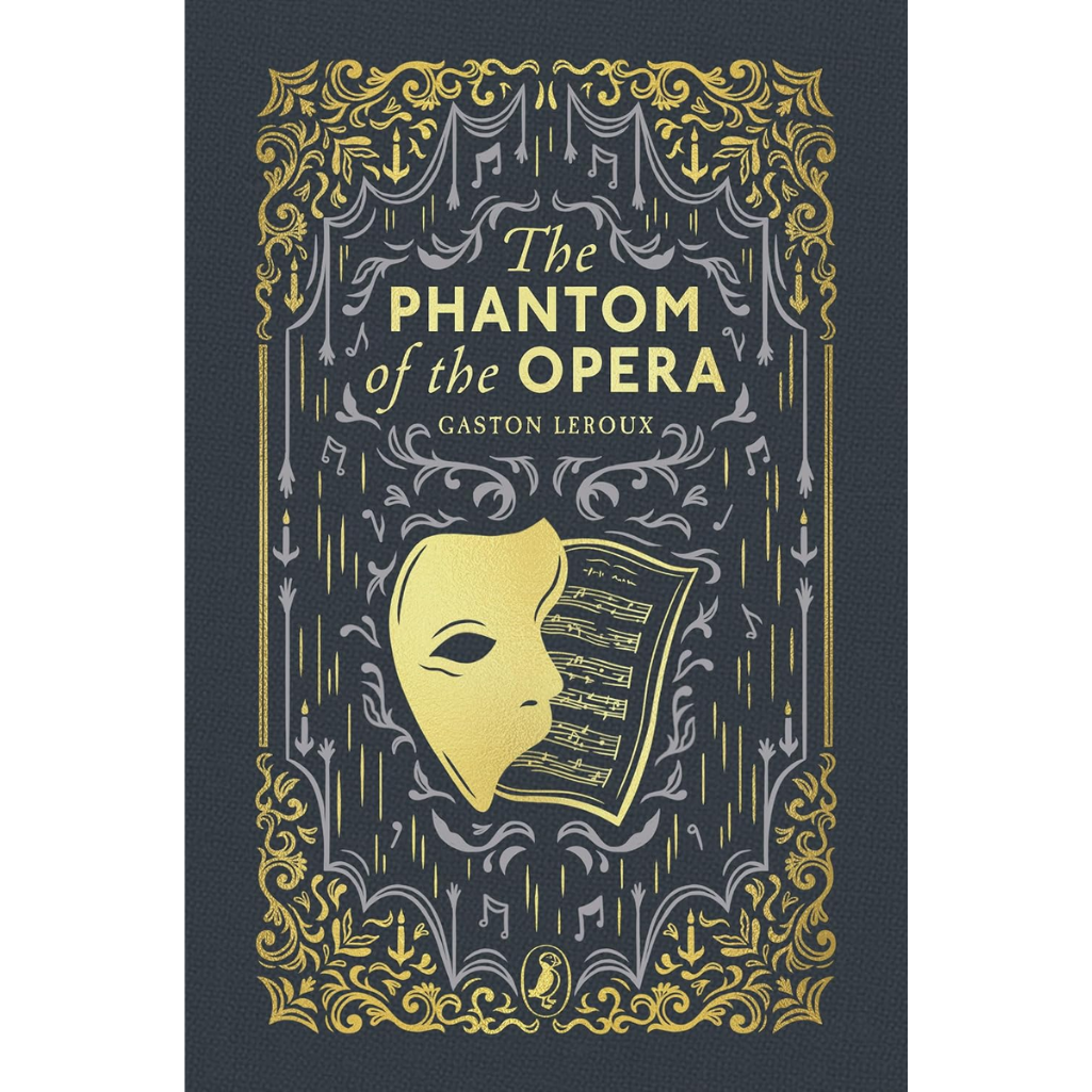 The Phantom of the Opera book cover by Gaston Leroux, featuring a dark navy blue textured background with ornate gold and silver theatrical illustrations, a gold mask, and a sheet of musical notation.
