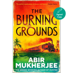 Book cover of 'The Burning Grounds' by Abir Mukherjee with a train and palm trees design.